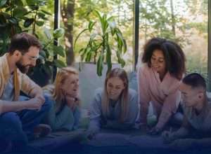 Students engaged in environmental education, collaborating in a bright, plant-filled space to learn about sustainability and nature.